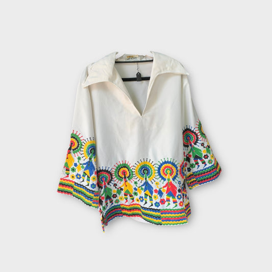 Blusa blanca con bordados de señor en las mangas “La cita”